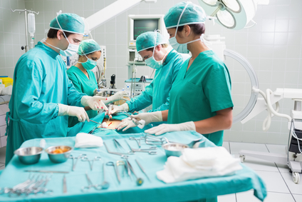 stockfresh 2731662 side-view-of-a-surgical-team-operating-a-patient-in-an-operation-theatre sizeXS
